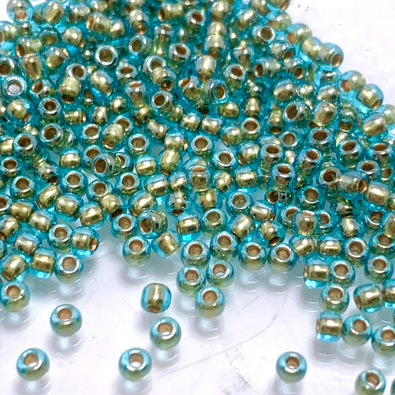 Aqua  Gold Lined Rainbow,  11/0 TOHO Round, 8.0 grams