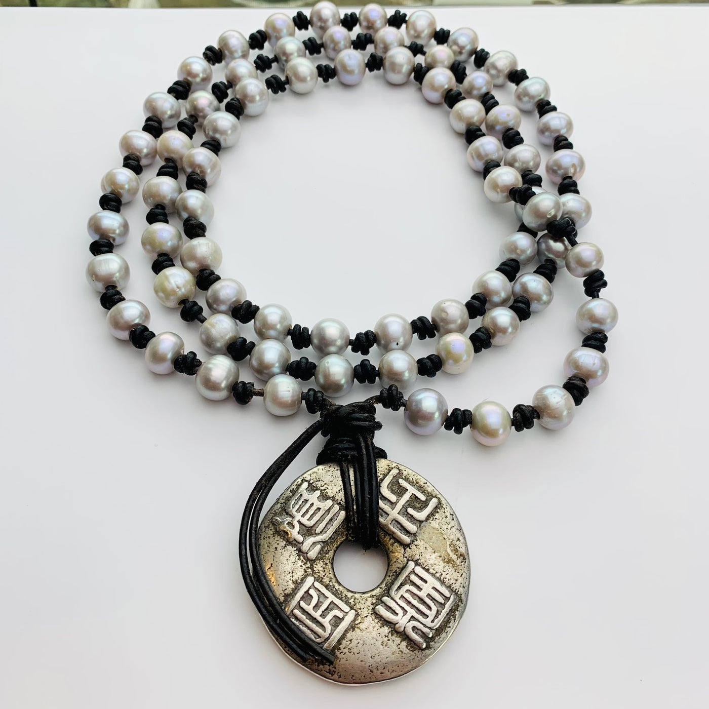 Long knotted pearl necklace sale