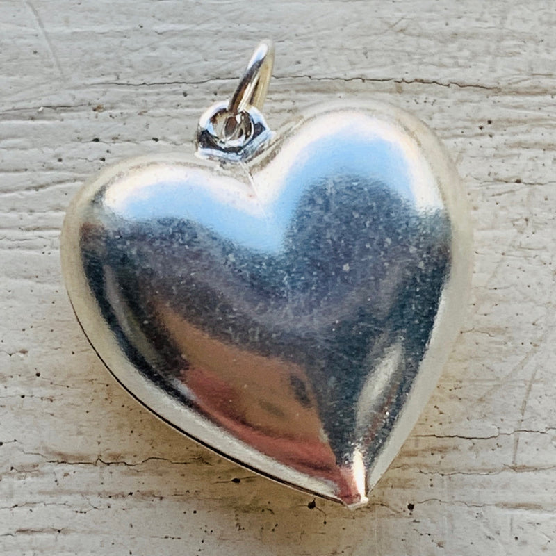 This silver plated puffed heart and  measures 17x12 mm